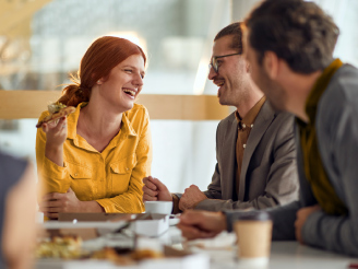 Employees enjoy a cheerful break in the company cafeteria as part of a workplace colorectal cancer screening initiative.