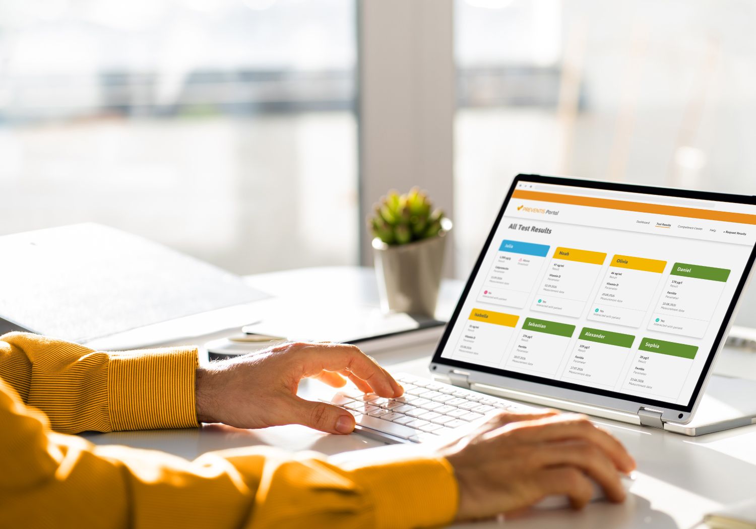 Healthcare professional using the Preventis Portal on a laptop to review patient test results.